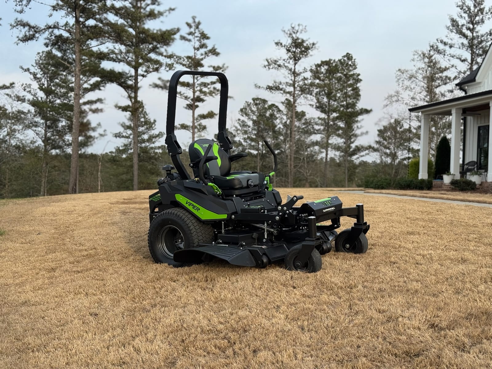 Viper commercial zero-turn mower parked on an open lawn with pine trees behind