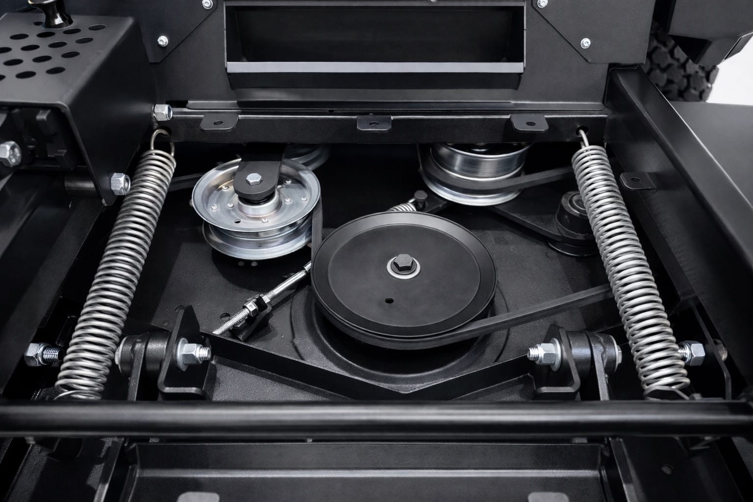 Underside of a Viper cutting deck showing spindle pulleys, the drive belt and idler springs