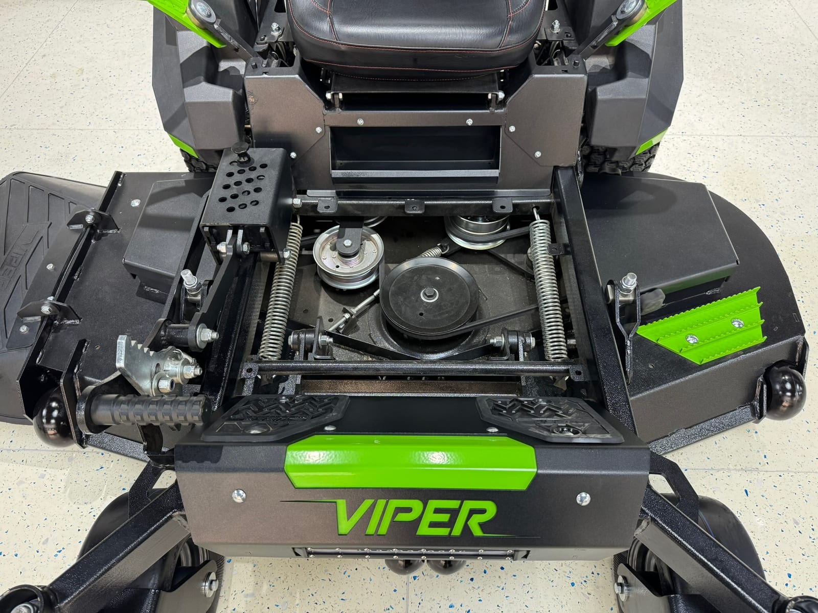 Under-deck/spindle view showing deck belt, pulleys and spindle area