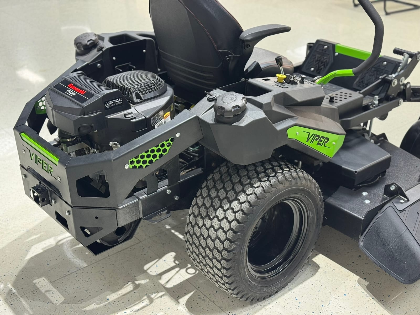 Studio close-up of a Viper zero-turn engine bay, fuel tank and rear drive tire