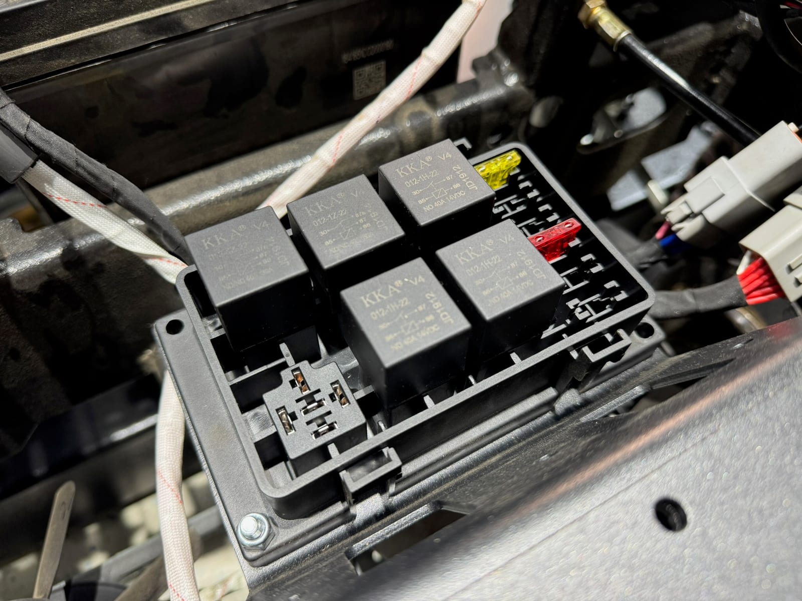 Electrical relay/fuse block with wiring harness exposed